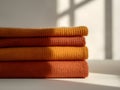 Cozy Stacked Orange Textiles with Window Light Royalty Free Stock Photo