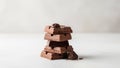 Stack of milk chocolate pieces with hazelnuts on a light background Royalty Free Stock Photo