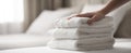 The neatly arranged stack of soft white towels on a bed..AI generated image Royalty Free Stock Photo
