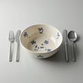 A neatly arranged table setting features a ceramic bowl with a delicate blue floral desi Royalty Free Stock Photo