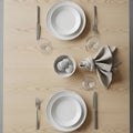 Neatly arranged table setting on a light wood surface. Two place settings with white plates, Royalty Free Stock Photo