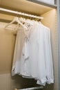 Neatly arranged white blouses on hangers in a closet Royalty Free Stock Photo