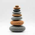 A neatly balanced stack of smooth stones is arranged in a gradient of colors from Royalty Free Stock Photo
