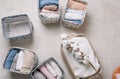 Neatly folded clothes in open organizer boxes, top view. a branch of cotton.