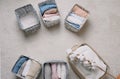 Neatly folded clothes in open organizer boxes, top view. a branch of cotton.