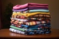 neatly folded colorful shirts stacked on a table