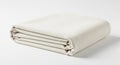 A neatly folded, cream-colored fabric with a smooth texture, possibly a tablecloth or Royalty Free Stock Photo