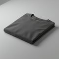 A neatly folded dark gray T-shirt is placed on a light gray surface. The shirt features a Royalty Free Stock Photo