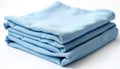 Neatly folded light blue fabric sheets stacked on white surface. Textile smooth, soft, wrinkle free. Used for home decor bedding Royalty Free Stock Photo