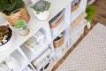 Neatly folded linen cupboard shelves storage at eco friendly straw basket placed closet organizer