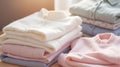 Neatly Folded Pastel Colored Clothes Stack on Wooden Surface Royalty Free Stock Photo