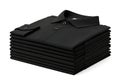 A neatly folded stack of black short-sleeved polo shirts on a white background Royalty Free Stock Photo