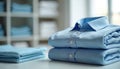Neatly folded stack of light blue cotton shirts. Clean, smooth fabric with crisp collars and white buttons. Arranged on a shelf, Royalty Free Stock Photo
