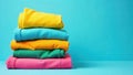 A neatly folded stack of vibrant colored shirts on a solid background. Generative AI Royalty Free Stock Photo