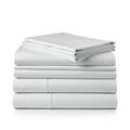 A neatly folded stack of white bed linens rests on a light surface. Royalty Free Stock Photo