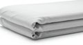 A neatly folded stack of white fabric, possibly bedsheets or similar cloth, with smooth Royalty Free Stock Photo
