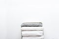 Neatly folded white and gray clothes in a container for a wardrobe or trip on white background. Royalty Free Stock Photo