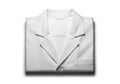 A neatly folded white lab coat with dark trim isolated on a clean white background isolated on white background Royalty Free Stock Photo