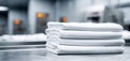 The neatly folded white linens stacked in a clean commercial laundry environment. AI generated image Royalty Free Stock Photo