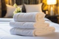 Neatly folded white towel on a luxurious hotel resort bed