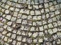Neatly laid out old paving stones. Pavement on the square of the old town. Square and rectangular stones on the ground, covered Royalty Free Stock Photo
