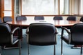 neatly lined up office chairs and round table in a meeting room Royalty Free Stock Photo