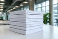 Neatly Stacked Blank Notebooks on a Table in Modern Office Environment with Natural Light Royalty Free Stock Photo