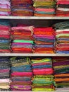 Neatly stacked colorful designer silk saris in racks in a textile shop. Incredible India