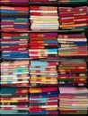 Neatly stacked colorful designer silk saris in racks in a textile shop. Incredible India