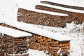 Renewable heat source firewood stacked in winter Royalty Free Stock Photo