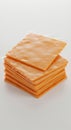 A neatly stacked pile of individually wrapped orange cheese slices is shown. Each Royalty Free Stock Photo
