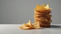 Neatly stacked pile of potato chips on white surface, no visible people in the image Royalty Free Stock Photo