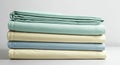 A neatly stacked set of folded bedsheets is displayed, featuring pastel colors. The top Royalty Free Stock Photo