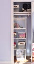 Simple organized built-in shelves in child\'s bedroom closet for easy clean up of toys and books Royalty Free Stock Photo