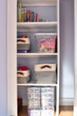 Simple organized built-in shelves in child\'s bedroom closet for easy clean up of toys and books Royalty Free Stock Photo