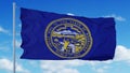 Nebraska flag on a flagpole waving in the wind, blue sky background. 3d rendering Royalty Free Stock Photo