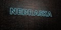 NEBRASKA -Realistic Neon Sign on Brick Wall background - 3D rendered royalty free stock image