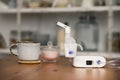 Nebulizer on the table with a cup and sugar bowl