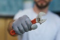 Necessary hand tool. Close up shot of hand of young repairman holding an adjustable wrench Royalty Free Stock Photo