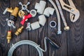 Necessary set of tools for plumbers on black vintage wooden background Royalty Free Stock Photo