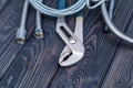 Necessary set of tools for plumbers on black wooden background Royalty Free Stock Photo