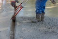 It is necessary to use a machine to align fresh concrete compacted layer on a new driveway construction project. Royalty Free Stock Photo