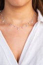 Young woman neck wearing a silver clear necklace. Beautiful valentine`s gift