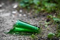 The neck of a broken green glass bottle lies on the street Royalty Free Stock Photo