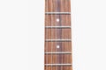 Neck of electric guitar with guitar fretboard. Part of body electric guitar with strings Royalty Free Stock Photo