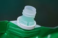 neck on a green plastic bag with a shampoo bottle Royalty Free Stock Photo