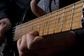 Neck of guitar with fingers playing it Royalty Free Stock Photo