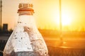 The neck of an open plastic bottle of lemonade