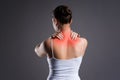 Neck pain, woman with backache on gray background Royalty Free Stock Photo