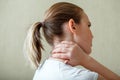 Neck shoulder pain, cervical vertebrae. Woman holds neck with pain cervical muscle spasm by hand. Disease of musculoskeletal